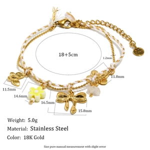 18K gold plated stainless steel bracelet with butterfly and floral pendants on white background