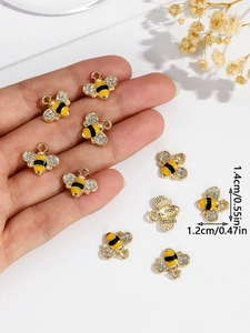 Detailed size view of yellow bee charm with rhinestones measuring 1.4cm by 1.2cm