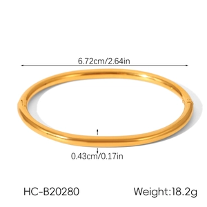 Polished gold stainless steel bangle showing size measurements 6.72cm inner diameter