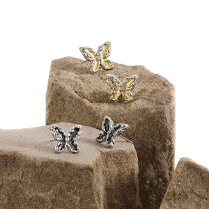 Elegant S925 silver butterfly stud earrings in gold and black on natural stone
