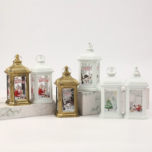 Close-up of LED Christmas lanterns with Santa and snowman prints on marble display stands