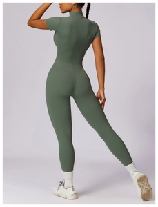 Rear view of grey-green yoga jumpsuit showing stretchy fabric and body-hugging fit