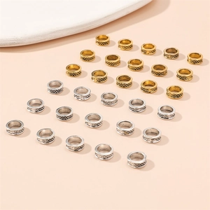 Macro shot of gold and silver textured metal hair rings for vintage braided hairstyles