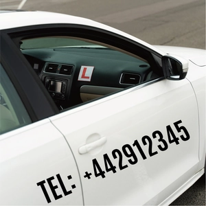 Detailed view of black vinyl letter and number stickers applied to a white car door surface