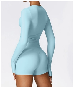 Detail of light blue brushed long sleeve yoga top with high waist athletic shorts