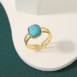 Bohemian gold multi-layer open ring featuring a cushion-cut turquoise stone on white stone