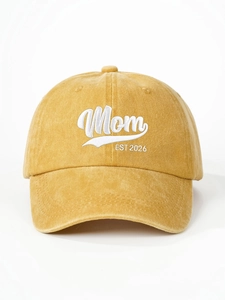 Detailed close-up of white Mom EST 2026 embroidery on mustard yellow washed cotton cap