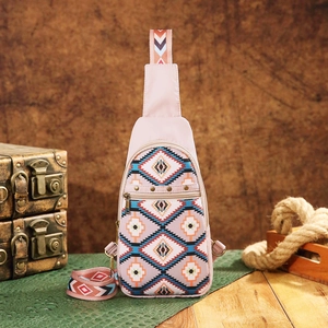 Pink Aztec bohemian sling bag with geometric patterns on a vintage explorer backdrop