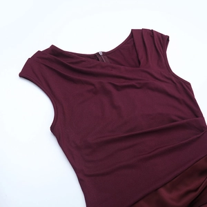 Detail of burgundy sleeveless evening dress featuring asymmetric pleats and invisible zipper