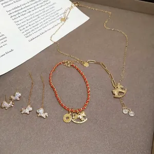 Elegant gold-plated horse jewelry set including necklace, red bracelet and earrings