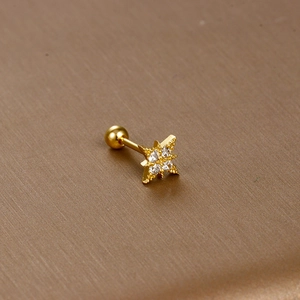 Detailed macro view of golden star-shaped stud earring with micro-inlaid cubic zirconia