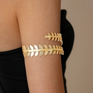 Detail of golden laurel leaf arm cuff featuring a double-layer wrap design on the upper arm