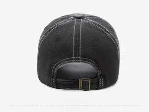 Detail of black washed cotton baseball cap featuring contrast stitching and metal buckle