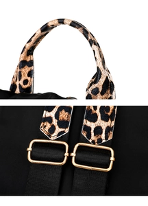 Close-up of backpack leopard print straps and golden metal adjustment buckles