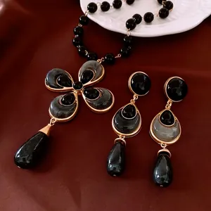 Vintage waterdrop floral beaded jewelry set with long necklace and drop earrings on silk