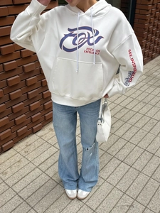 Detail of street style white hoodie showing focus on excellence print and front pocket