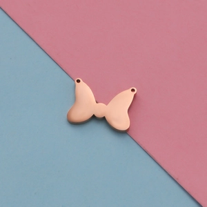 Close-up of rose gold bow-shaped stainless steel pendant with two connection holes