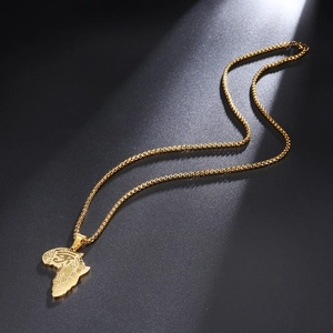 Detailed view of golden Africa map pendant with Eye of Horus symbol and geometric patterns