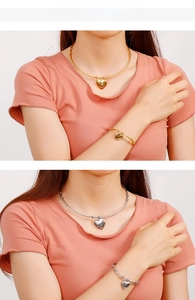 Polished heart pendant choker and bangle set shown on model in gold and silver finish