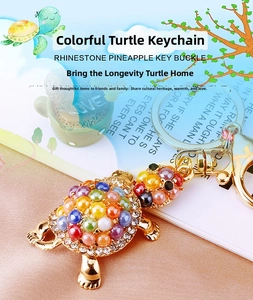 Detailed close-up of a colorful rhinestone turtle keychain with gold metal plating