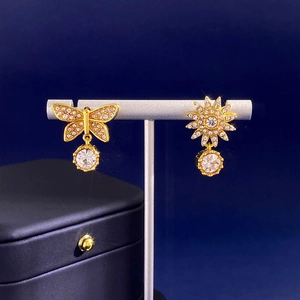 Elegant asymmetrical gold butterfly and sunflower drop earrings with sparkling crystals
