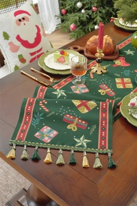Christmas table runner with festive jacquard patterns and green tassels detail
