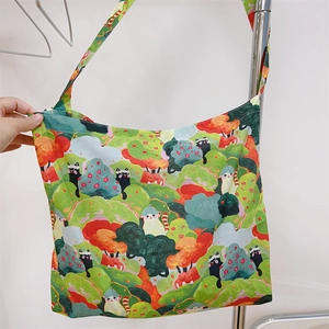 Detail of soft cotton tote bag with cute cartoon forest and cat print patterns