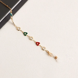 Detail of gold glasses chain with colorful enamel hearts and transparent beads