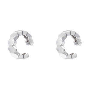 Detailed macro view of faceted silver C-shape ear cuffs with geometric texture