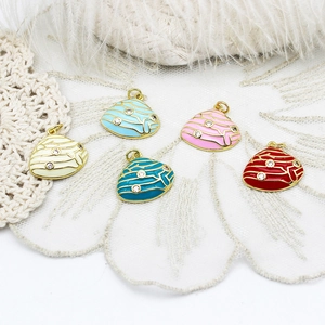 Detailed view of colorful seashell pendants with crystals on white lace and feather backdrop