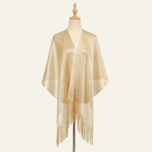 Elegant champagne gold shawl with metallic shimmer and long fringe trim on a mannequin