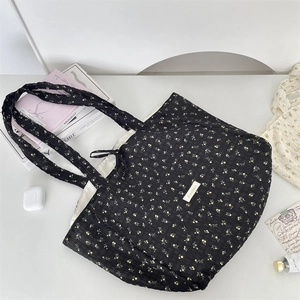 Floral chiffon tote bag detail featuring pleated texture and branded Soraikka woven label