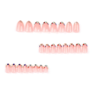 Press-on nail set with nude pink base, champagne gold glitter and colorful rhinestones