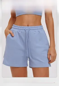 Detail of light blue athletic shorts showing elastic waistband and drawstring texture