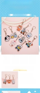 Close-up of cute cartoon puppy and rabbit acrylic keychain with metal lobster clasp detail