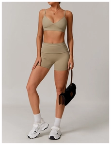 Detailed side view of khaki yoga set with V-neck sports bra and high-waisted gym shorts