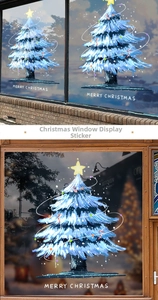 Detail of blue Christmas tree window sticker with Merry Christmas text on glass surface
