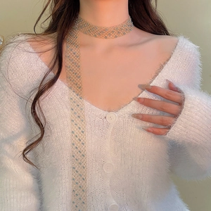 Detail of light gold mesh choker necklace with light blue beads on woman's neck