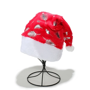 Red plush Christmas hat with silver feathers and white faux fur trim on a stand
