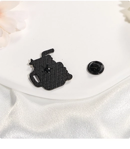 Detailed close-up of the black enamel brooch back with anti-slip texture and metal pin