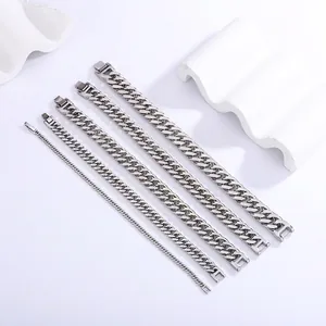 Polished silver stainless steel Cuban link bracelets in five widths on white display