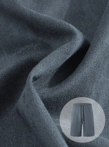 Close-up of soft grey knit fabric texture on men's drawstring shorts with a detail inset