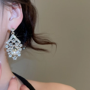 Elegant water-drop rhinestone earring pendant shown on a model in a high-fashion profile shot