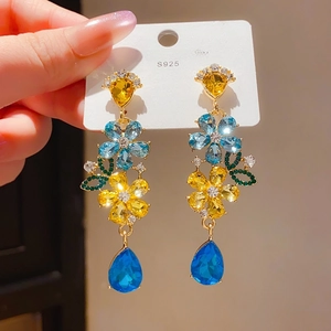 Detail of vintage teardrop earrings with S925 silver needles and colorful crystals