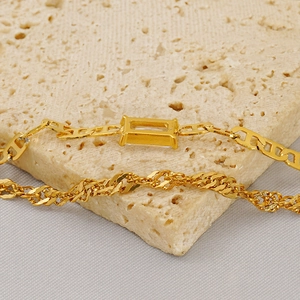 Double-layered gold titanium steel bracelet with geometric crystal pendant on stone base