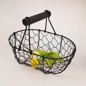 Minimalist black wire mesh storage basket with wooden handle for fruit and snacks