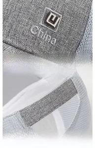 Close-up of metal logo plaque, China embroidery, and adjustable back strap on mesh cap