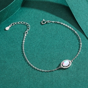 Elegant S925 sterling silver moonstone bracelet with oval gem and zirconia on green paper