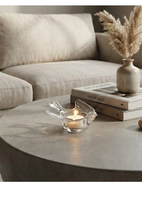 Macro shot of minimalist bird glass candle holder with tea light and wing detail