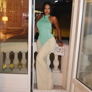 Fashionable backless halter dress in mint green and beige with a pleated maxi skirt detail